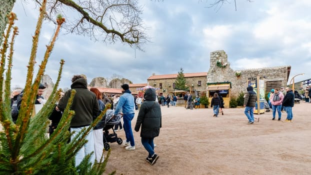 Tiffauges, Vendee, France - December 8, 2024: Street atmosphere and architecture at the Christmas Market at Tiffauges Castle on a gray winter day
