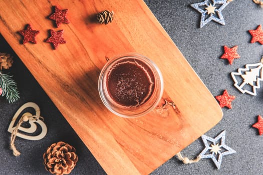 Traditional hot chocolate with Christmas decorations in Studio