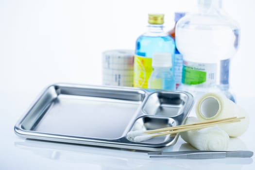 Medical equipment for treating infections. Wound care dressing set. Medical supplies for nurses. Conform bandage, forceps, cotton stick, alcohol. Sterile dressing materials. Healthcare equipment.