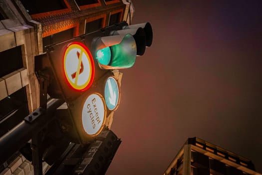 Traffic lights and buildings at night. Shooting Location: UK, London