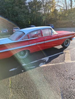 VELBERT, NRW, GERMANY - NOVEMBER 10, 2020: Velbert, Nrw, Germany - November 10, 2020: Rear view of a red colored 1960 Chevrolet Impala in a public parking lot