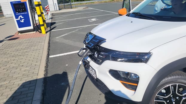 HEILIGENHAUS, NRW, GERMANY - AUGUST 10, 2022: Heiligenhaus, Nrw, Germany - August 10, 2022: Brand new electric Dacia Spring automobile being charged