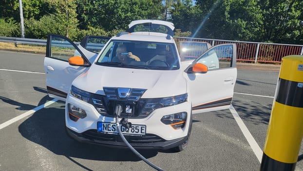 HEILIGENHAUS, NRW, GERMANY - AUGUST 10, 2022: Heiligenhaus, Nrw, Germany - August 10, 2022: Brand new electric Dacia Spring automobile being charged
