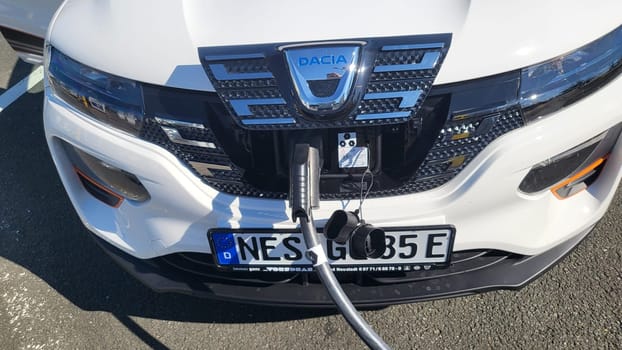 HEILIGENHAUS, NRW, GERMANY - AUGUST 10, 2022: Heiligenhaus, Nrw, Germany - August 10, 2022: Brand new electric Dacia Spring automobile being charged