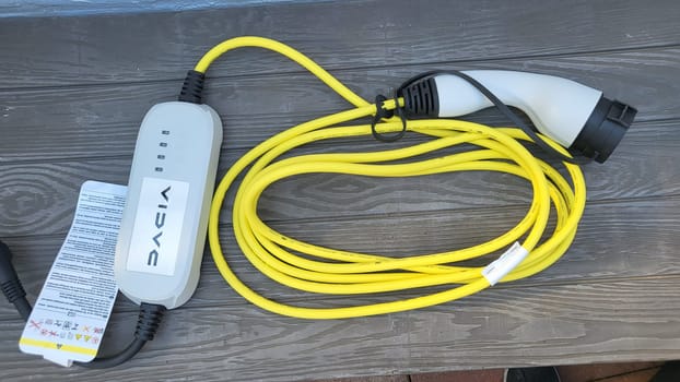 HEILIGENHAUS, NRW, GERMANY - AUGUST 16, 2022: Heiligenhaus, Nrw, Germany - August 16, 2022: Mobile charging station, wall box with yellow cable and Schuko plug for electric cars