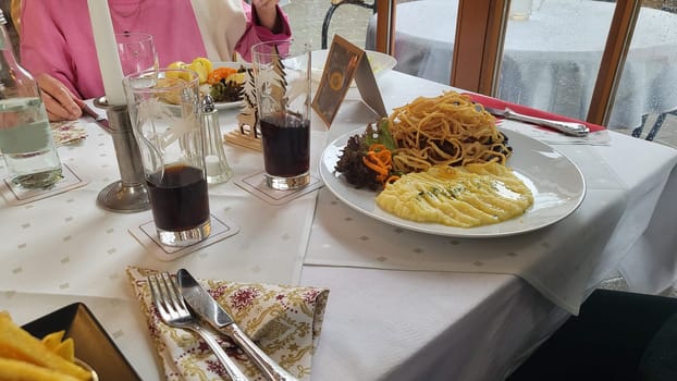A classic Viennese schnitzel served with a side of creamy potato salad and crispy fried onions