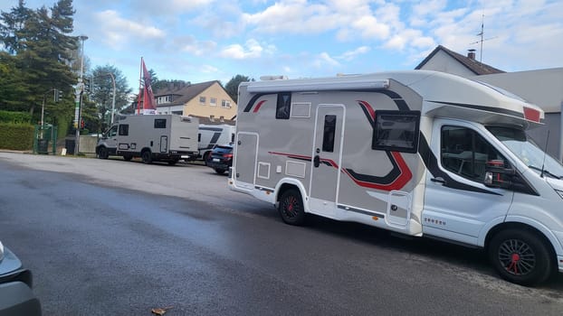 A group of campervans parked at a dealership, waiting for new owners.