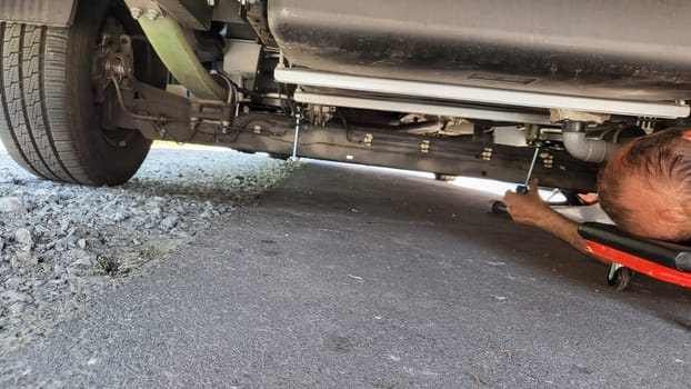 VELBERT, NRW, GERMANY - June 16, 2022: Installation of an additional air suspension in a mobile home to increase the load capacity