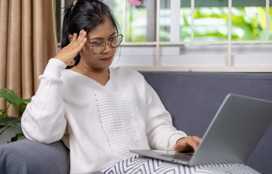 Woman working from home and have stress from work, Women working about new startup on laptop to analysis finance of project in outside office, Woman working using laptop online meeting in home office.