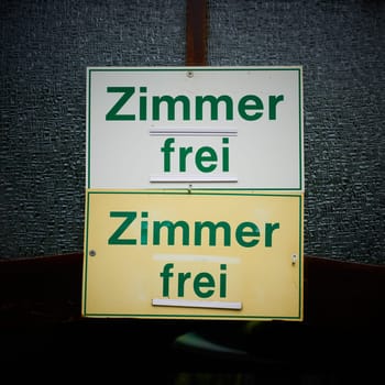 Signs on the door of a guesthouse with the german inscription Zimmer frei. Translation: Room free