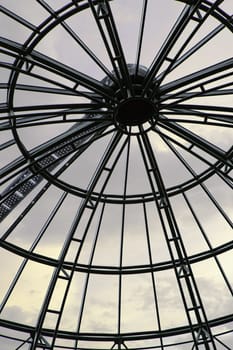 Glass rotunda and cloudy sky in the background