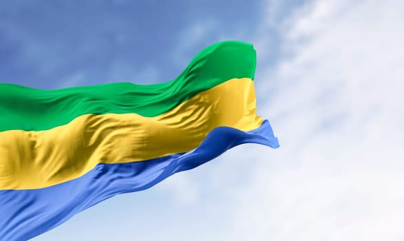 National flag of Gabon waving in the wind on a clear day. Three equal horizontal bands of green, yellow, and blue. 3d illustration render. Fluttering fabric
