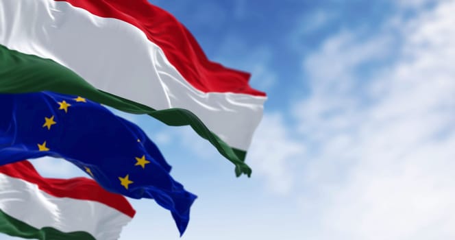 Flags of Hungary and the European Union fluttering together on a clear day. Member of the European Union on 2004. 3d illustration render.
