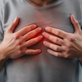 Male adult experiencing chest pain or heartburn with radiating red highlight.