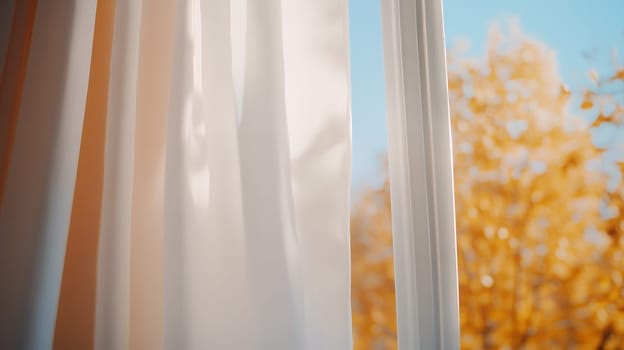 Sunlight filters through white curtains, revealing a vibrant autumn landscape with golden foliage.
