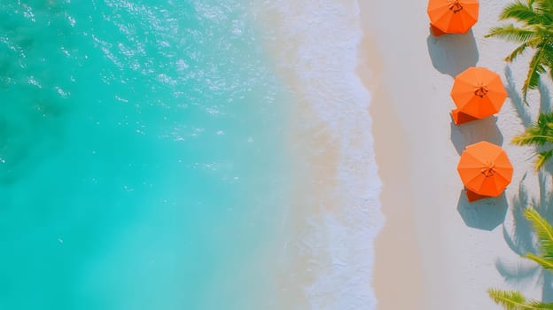 Aerial view of orange umbrellas lined on a beach against turquoise waters, creating a vibrant coastal scene.