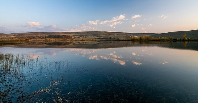 Lake in the Altai Mountains. Panorama of the Altai landscape in the mountains. The time of year is autumn.