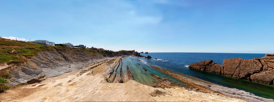 Broken coast at Liencres Cantabria , on a sunny summer day, low tide. Empty beach, low tide, clear sky, aerial view