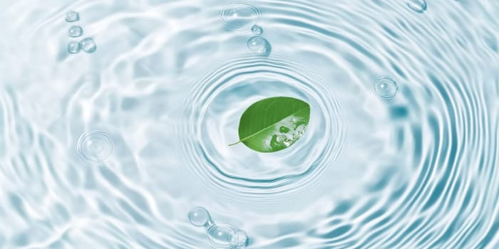 A green leaf floating on water showing ripples and bubbles, suitable as SPA background, AI generated