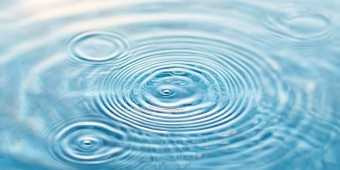 Ripples in clear blue water with abstract circular patterns, suitable as calming SPA background, AI generated