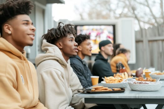 Friends watching Super Bowl football game eating snacks together at home, AI generated