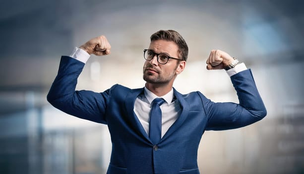 Confident businessman flexing arms muscles imagine super power. Fit business person in a confident and strong pose