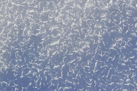 Close-up of snowflakes and ice crystals on the ground