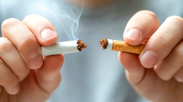Breaking a cigarette symbolizes quitting smoking and taking control of health. Inspire a healthier lifestyle by overcoming addiction to nicotine