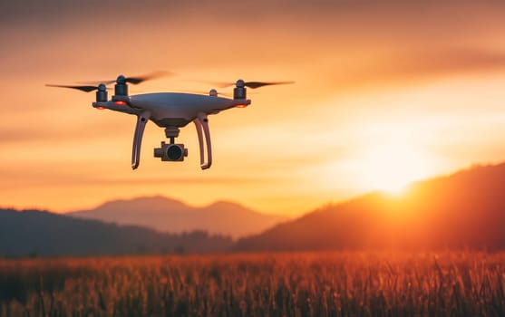 Quadcopter drone hovering over golden wheat field with mountains in the background during a colorful sunset, illustrating modern agricultural technology.