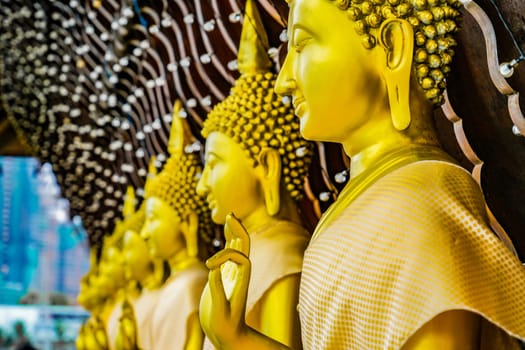 Procession of golden Buddha statues. Shooting Location: Thailand, Bangkok