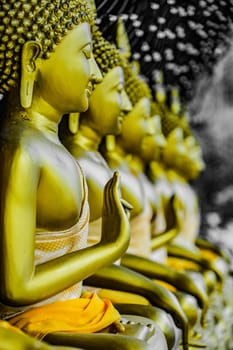 Golden Buddha statue with hands raised in prayer. Shooting Location: Thailand, Bangkok