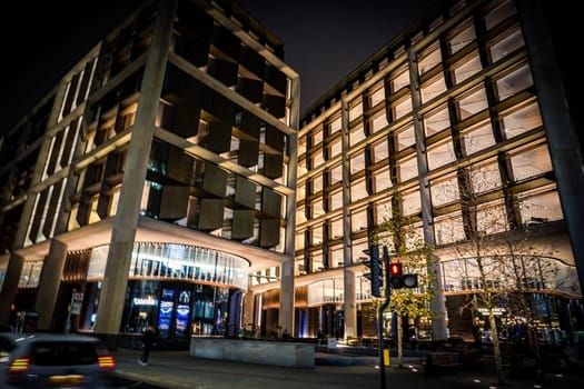 Buildings and street trees at night. Shooting Location: UK, London