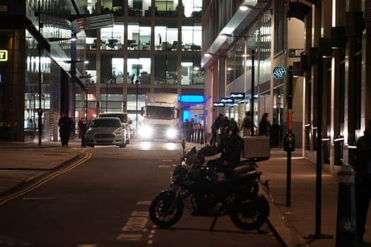 Bikes and buildings in the city at night. Shooting Location: UK, London