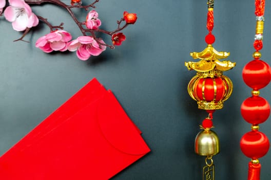 Chinese New Year decoration with red packets on black cover background with customizable space for text. Chinese New Year celebration.