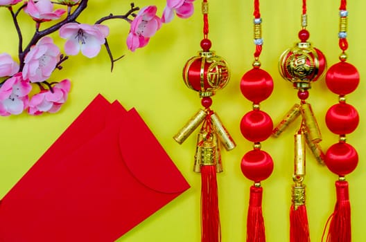 Chinese New Year decoration and red packets on yellow cover. Chinese New Year celebration concept.