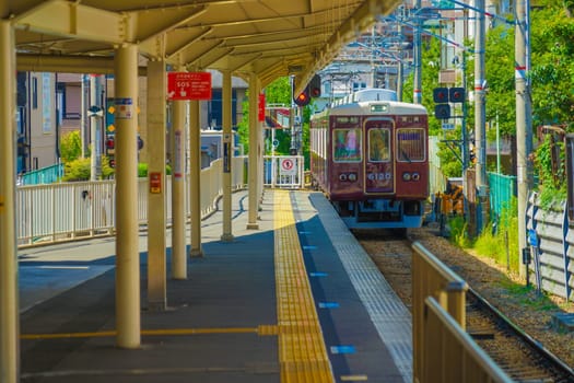 brown train stopping at the station. Shooting Location: Kobe City, Hyogo Prefecture