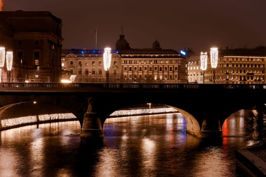 Bridge and illuminated buildings at night. Shooting Location: sweden, stockholm