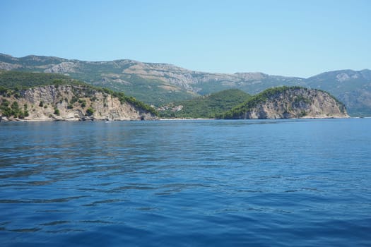 RT Dubovica Rocks near Buljarica and Svetac Rock, Montenegro. Stones inaccessible rocks. Flysch marine lithological layers. Adriatic Mediterranean sea blue water. Nature park Katici. District Budva