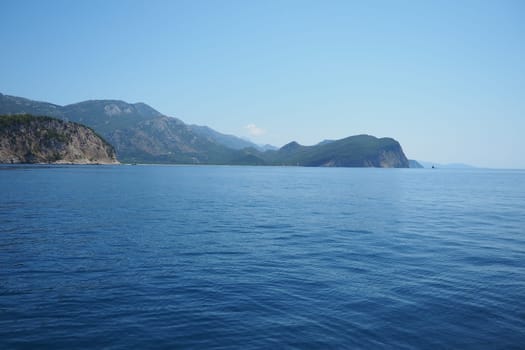 RT Dubovica Rocks near Buljarica and Svetac Rock, Montenegro. Stones inaccessible rocks. Flysch marine lithological layers. Adriatic Mediterranean sea blue water. Nature park Katici. District Budva