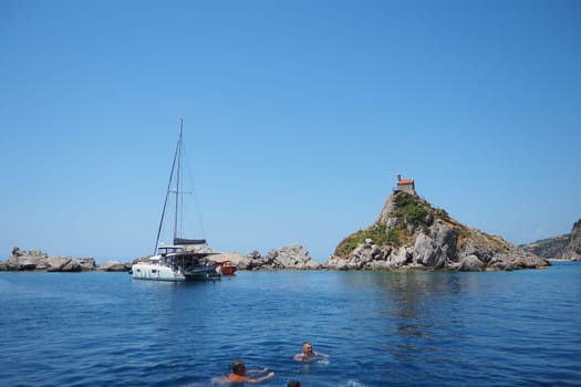 Petrovac, Montenegro, 07.27.24: Katic and Sveta Nedelja are two small islets on the Adriatic Sea, located opposite of the town of Petrovac in the Montenegrin municipality of Budva. Church on the rock.