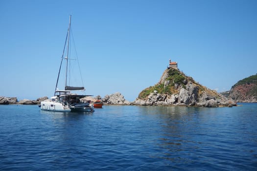 Petrovac, Montenegro, 07.27.24: Katic and Sveta Nedelja are two small islets on the Adriatic Sea, located opposite of the town of Petrovac in the Montenegrin municipality of Budva. Church on the rock.