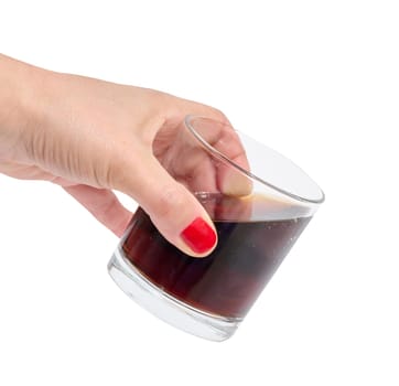 Female hand holding glass with drink on isolated background
