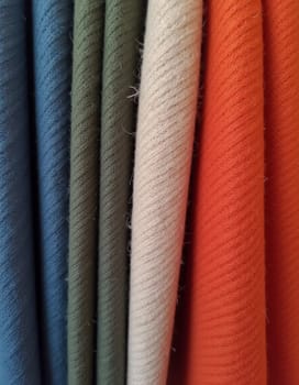 Various samples of woolen fabric in different colors are neatly organized, showcasing a vibrant palette ideal for textile design and creative projects. Generative AI.