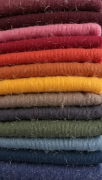 Various samples of woolen fabric in different colors are neatly organized, showcasing a vibrant palette ideal for textile design and creative projects. Generative AI.