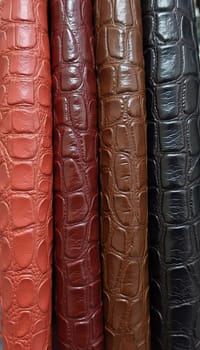 Different samples of genuine crocodile leather are arranged in vibrant colors. Each piece showcases unique textures and finishes, appealing to leather enthusiasts and designers. Generative AI.
