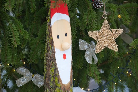 Decorative Santa and star ornaments on a fir tree, capturing the essence of holiday spirit and charm