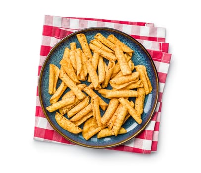 Rolled nachos tortilla chips on plate isolated on a white background.