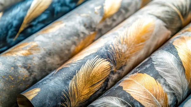 Rolls of wallpaper with a feather pattern in gold and gray colors are creating a luxurious and elegant atmosphere, perfect for adding a touch of sophistication to interior design projects
