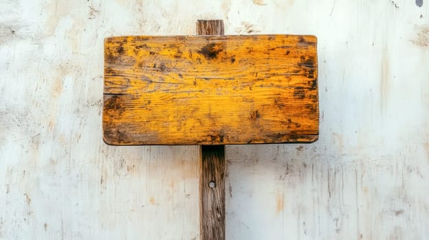 Old, weathered wooden sign hanging on a blank wall, offering ample copy space for messages or designs. Featuring a rustic, textured background, perfect for creative projects