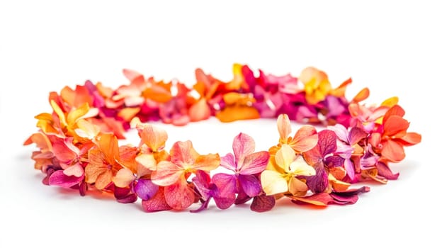 Beautiful floral crown made of small, colorful flower petals arranged in a circular shape, creating a vibrant and decorative accessory against a clean white backdrop